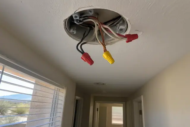 Electrical troubleshooting of spliced wires in a hallway ceiling junction box in Chandler, AZ.