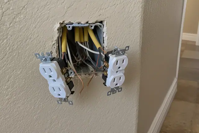 Tamper-resistant duplex electrical receptacles wired into a flush wall box in Goodyear, AZ.