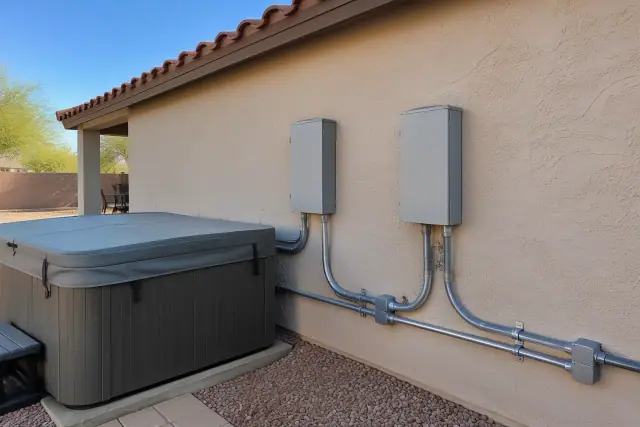 Hot tub and spa electrical circuit installation on a residential stucco wall in Phoenix, AZ.