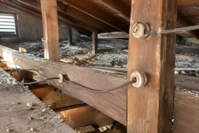 Attic framing with vintage knob and tube wiring in Phoenix, AZ.