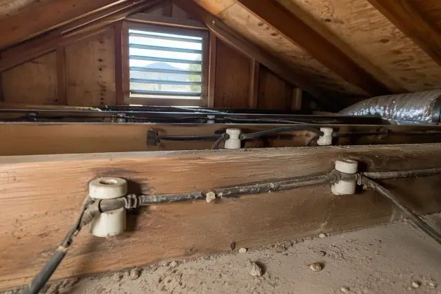 Knob and tube wiring replacement in a residential attic in Phoenix, AZ.