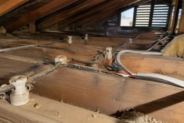 Attic whole-house rewiring showing old knob and tube wiring replacement in Avondale, AZ.