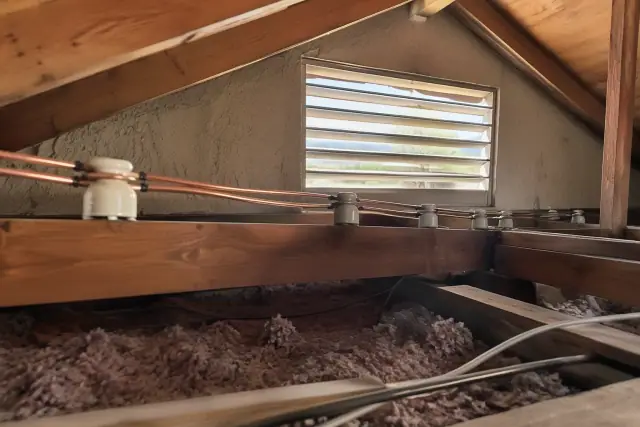 Vintage knob and tube wiring replaced with new copper conductors in an attic in Phoenix, AZ.