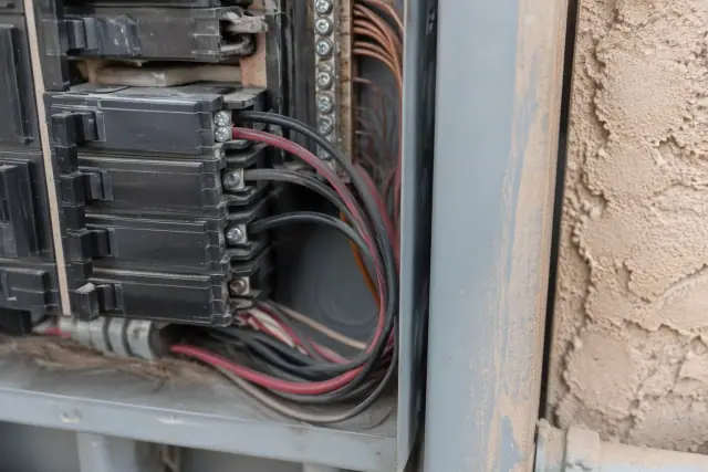 Electrical panel in Phoenix, AZ showing two wires under a single-rated breaker terminal.