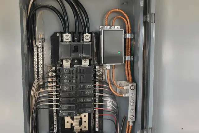 Surge protection module wired next to the main breaker bus during a whole house rewiring in Scottsdale, AZ.