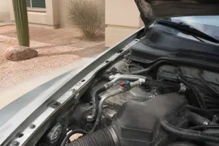 Finished AC service hoses and caps in a car engine bay at a Phoenix, AZ residence.