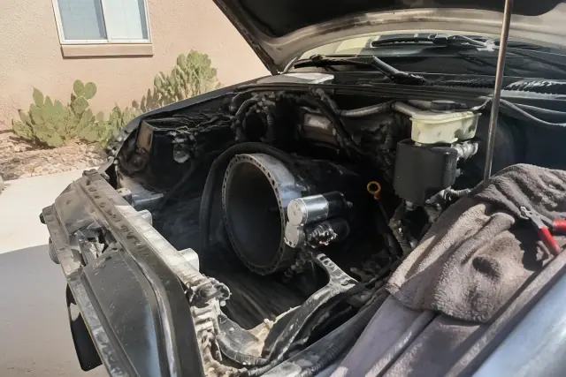 Vehicle starter motor beside the bell housing on a concrete pad at a Phoenix, AZ home.