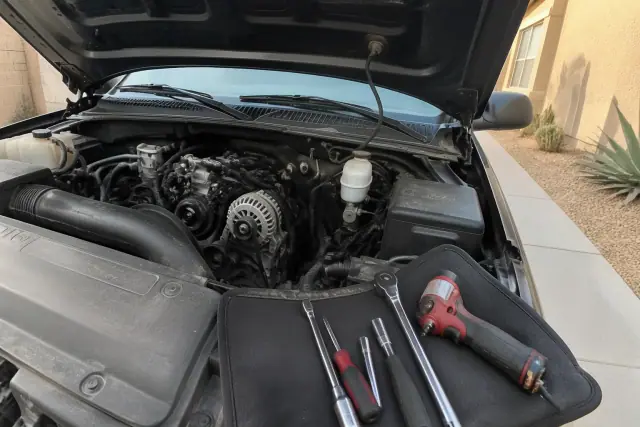 New alternator installed in a vehicle engine bay at a residence in Phoenix, AZ.