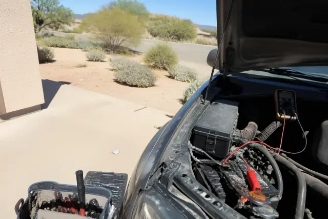 A mechanic performs diagnostic battery and starter service on a car at a residence in Phoenix, AZ.