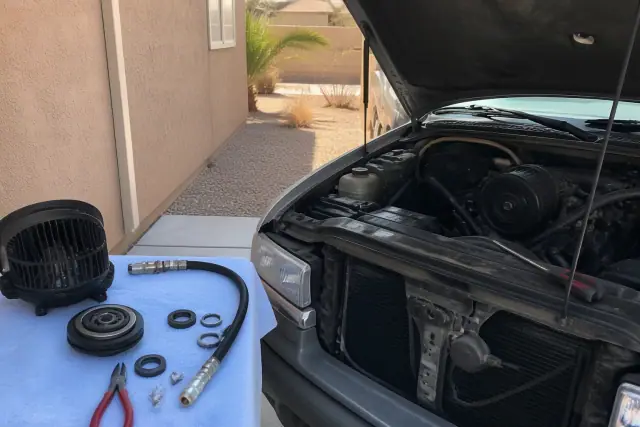 Vehicle AC repairs including blower, clutch, hose, and seal work in progress at a residential home in Phoenix, AZ.