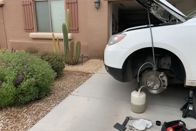 Brake fluid flush in progress on a car parked at a residential home in Phoenix, AZ.