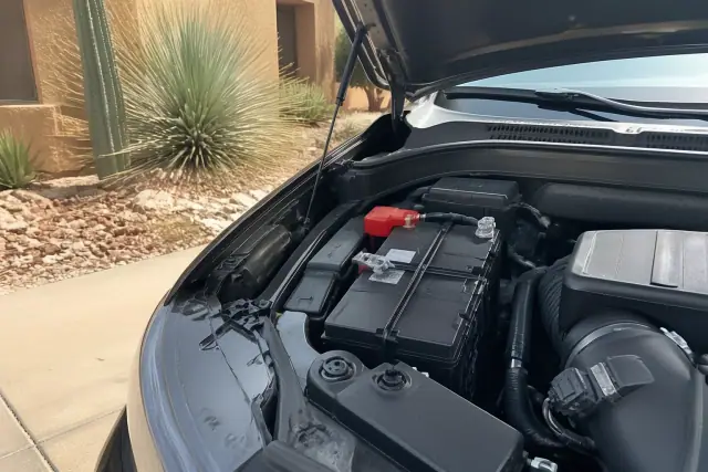 New car battery installed in a vehicle engine bay at a home in Scottsdale, AZ.