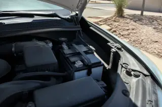 New car battery with clean terminals installed in an open engine bay in Phoenix, AZ.