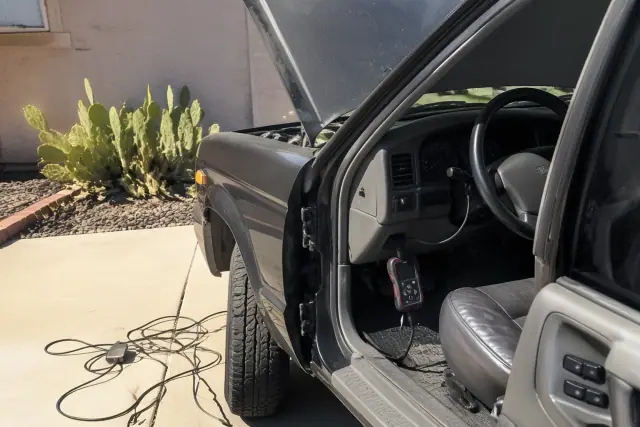A mobile mechanic performs check engine light diagnostics on a car in an Avondale, AZ driveway.