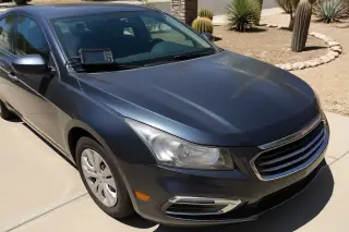 OBDII diagnostic tool on a car windshield after a completed check engine light service in Phoenix, AZ.