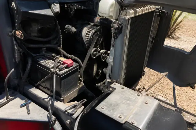 Open engine compartment showing belts and alternator during maintenance in Phoenix, AZ.