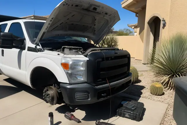 Technician performing a commercial vehicle inspection in a residential yard in Phoenix, AZ.