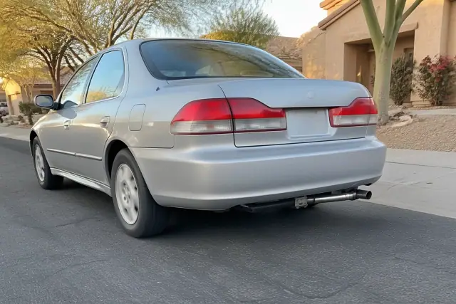 A car being road-tested on a residential street in Phoenix, AZ, showing the new exhaust weld under the rear bumper.