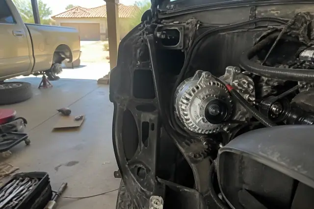 High-output truck and van alternator installed in a vehicle engine bay at a residential garage in Phoenix, AZ.