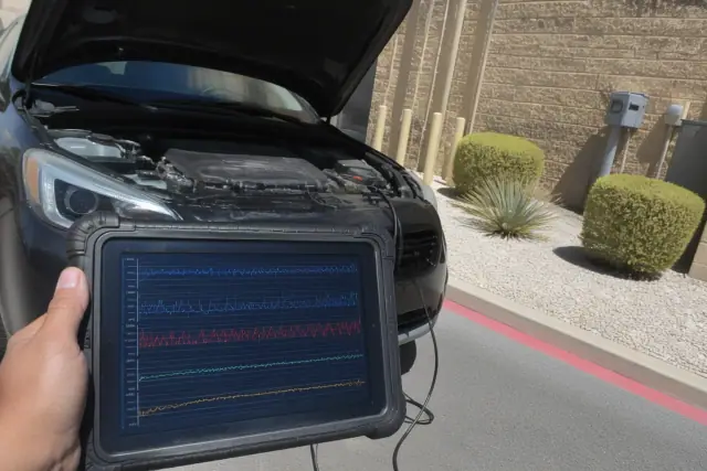 A smartphone screen showing live sensor data during a mobile vehicle diagnosis in a utility area in Phoenix, AZ.