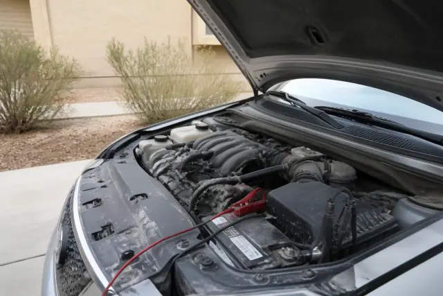 A mobile mechanic performs a pre-purchase car inspection on a vehicle in a Mesa, AZ driveway.