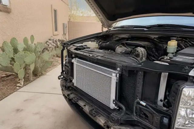 Engine bay with new cooling components under the hood of a car at a home in Peoria, AZ.