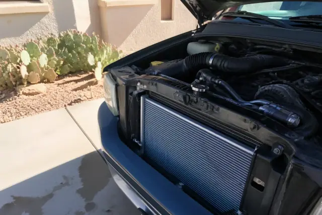 A new radiator and hoses installed in a vehicle engine bay at a home in Scottsdale, AZ.