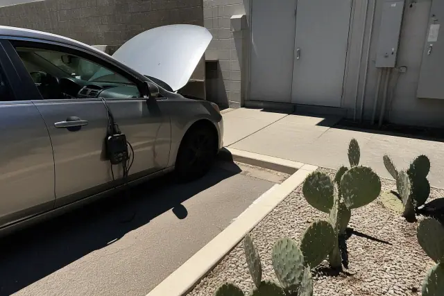 Diagnostic scanner connected to a vehicle for testing at a utility workspace in Phoenix, AZ.