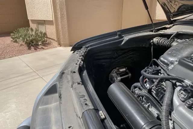 New starter motor and wiring harness installed in a vehicle engine bay at a residence in Phoenix, AZ.