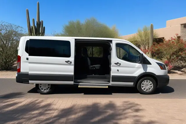 Medical transport van with open side doors parked curbside for boarding in Scottsdale, AZ.