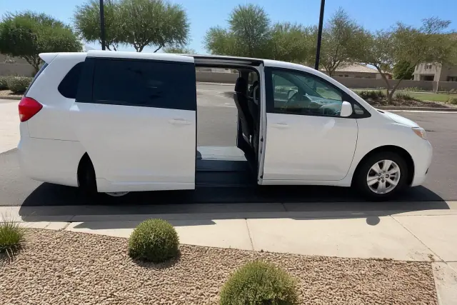 Medical transport vehicle with open side doors for curbside passenger boarding in Avondale, AZ.