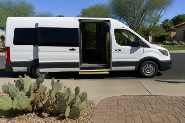 Medical transport van with open doors parked at a home in Glendale, AZ with desert landscaping.
