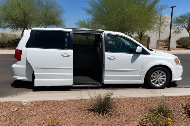 Medical transport van with side doors open for boarding parked at a curbside in Peoria, AZ.