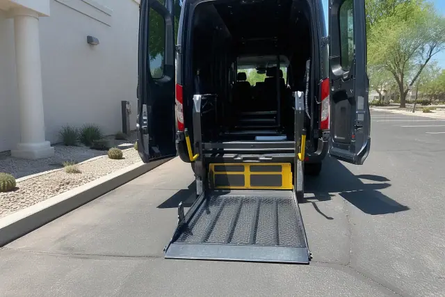 Automated hydraulic lift ramp lowered for medical transport in Tempe, AZ.