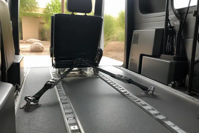 Bariatric medical transport vehicle interior with secured tie-down straps in Scottsdale, AZ.