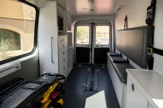 Interior of a bariatric transport vehicle with secure restraints and cabinetry visible in Phoenix, AZ.