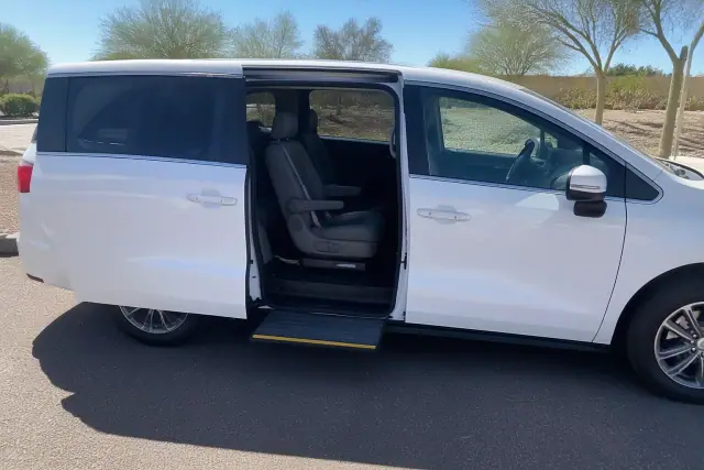 Medical transport vehicle with open side door and step for dialysis patient boarding in Tempe, AZ.