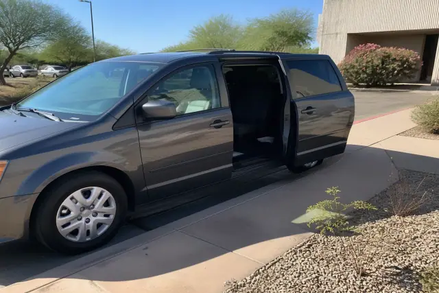 A medical transport van with open side doors parked on a concrete surface in Phoenix, AZ.