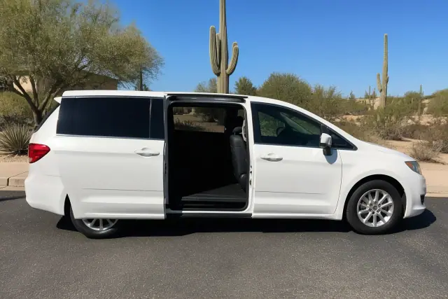 Medical transport vehicle with open side doors parked on a street in Scottsdale, AZ.