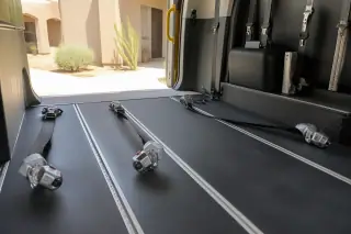 Interior floor tracking and four-point tie-down straps in a dialysis transport van in Phoenix, AZ.