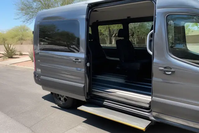 A transport van with an open side door and deployed step for dialysis assistance at a curbside in Phoenix, AZ.