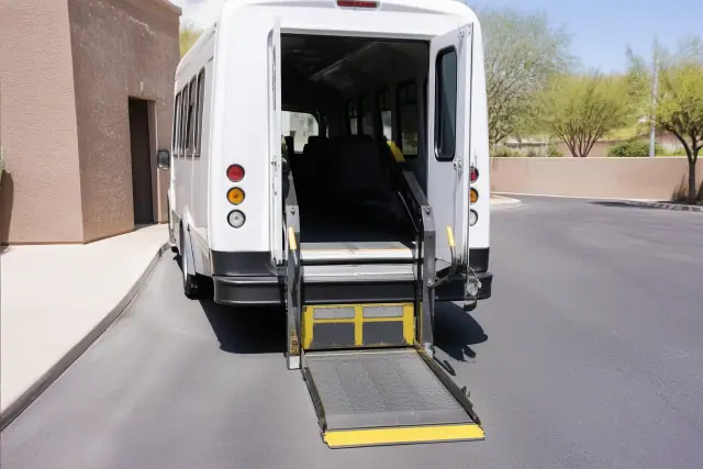 Hydraulic lift ramp deployed for door-to-door medical transportation on a street in Glendale, AZ.