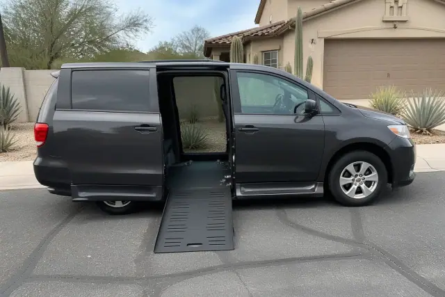 Medical transport van parked at a Phoenix, AZ home with side doors open and ramp visible.