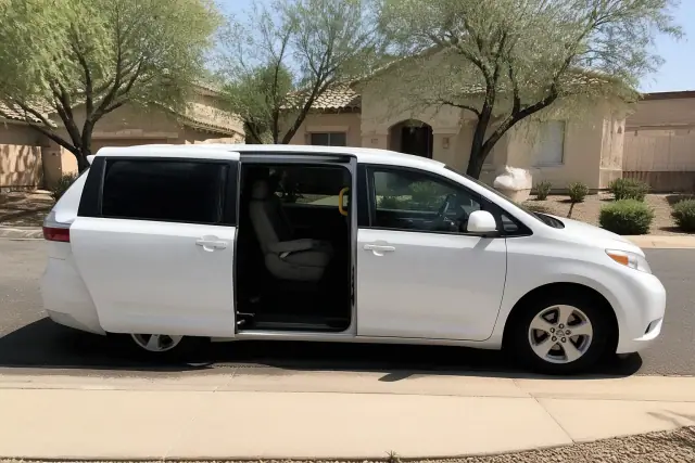 Medical transport van with side doors open for curbside passenger assistance at a home in Mesa, AZ.