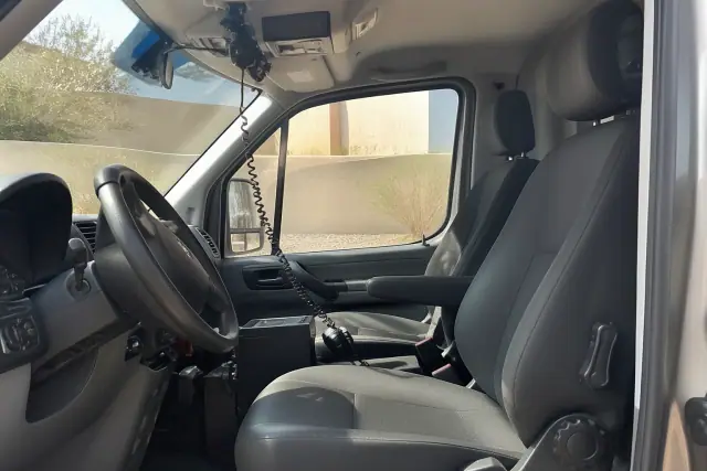Interior view of a bariatric transport vehicle cabin showing radio equipment in Phoenix, AZ.