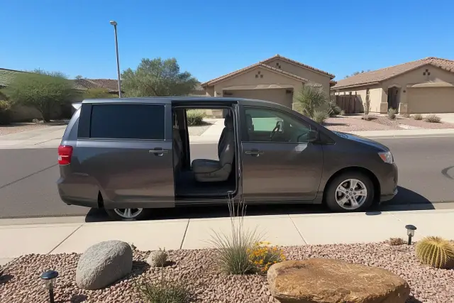 Medical transport vehicle with open side doors parked at a residential curb in Gilbert, AZ.