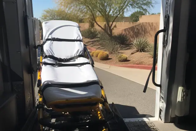 Stretcher secured at the rear doors of a transport vehicle during a hospital discharge in Phoenix, AZ.