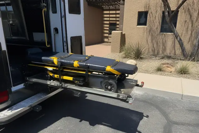 Stretcher secured in a transport vehicle for a medical transfer in Phoenix, AZ.