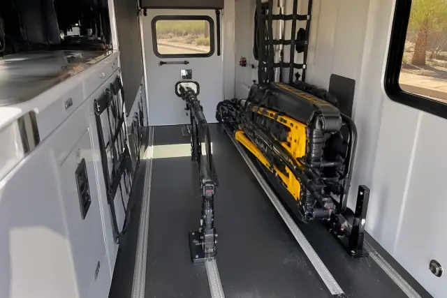 Interior view of a medical transport vehicle with secured equipment and desert scenery visible in Peoria, AZ.