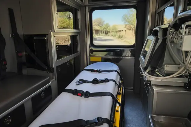 Rear interior of a medical transport ambulance with equipment in Scottsdale, AZ.
